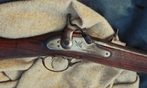 a close up of a rifle on a blanket